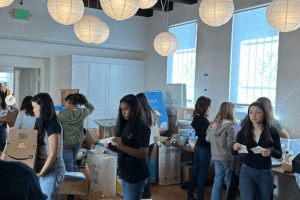 8th graders helping unpack and organized donations to Harvest Home